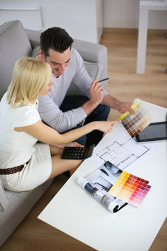 Couple looking at paint colors for new home
