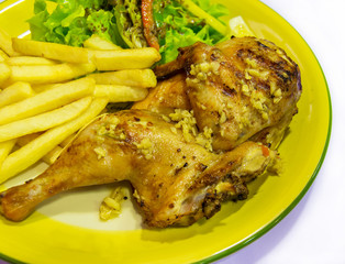 Roast chicken legs with garlic and french fries
