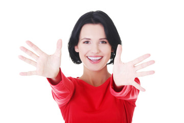 Woman pointing with both hands towards the camera