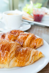 Breakfast with coffee and croissants