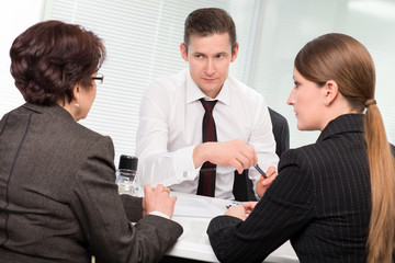 Agent with senior woman and her daughter