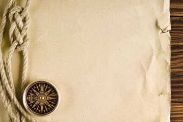 Rope and compass on the old paper background