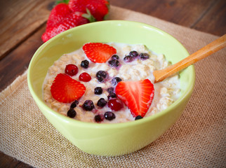 porridge with fresh strawberry, blueberries and cranberry