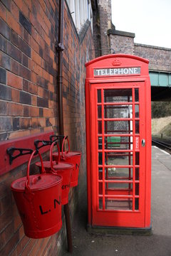 old fashioned telephone box and fire buckets