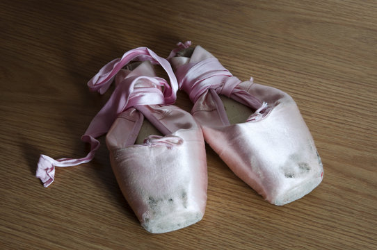 Detail of pointe shoes on wooden floor