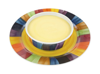 Fototapeta premium Cheddar cheese soup in bowl on plate