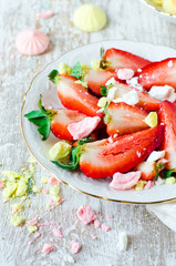 Fresh strawberries with pieces of meringue