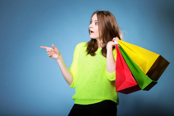 surprised girl with paper colorful shopping bag