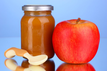 Useful and tasty baby food with apple and spoon