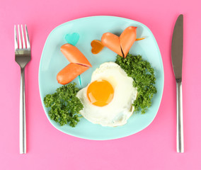 Sausages in form of hearts, scrambled eggs and parsley,