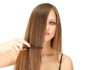 Obraz premium Portrait of beautiful woman brushing her hair, isolated on