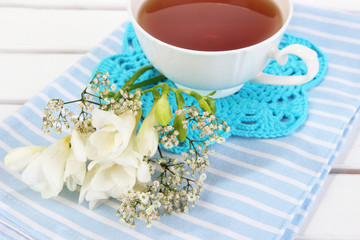 Beautiful composition with cup of tea and flowers