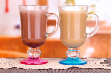 Layered coffee in glass on table on bright background