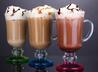 Layered coffee in glass on table on grey background