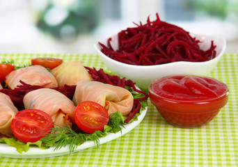 Stuffed cabbage rolls on table in room