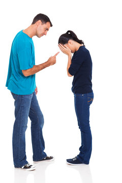 man pointing his crying girlfriend