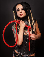 Erotic woman in corseat and with whip