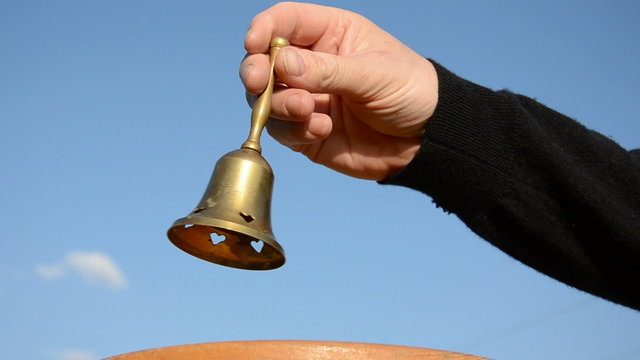 Hand bell in the woman's hand Stock Photo by ©Lebval 7457340