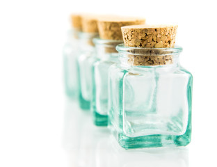 Cork stopper and small glass bottle with white background