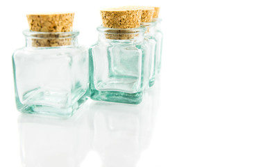 Cork stopper and small glass bottle with white background