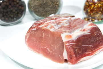 Fresh pork meat on white plate.