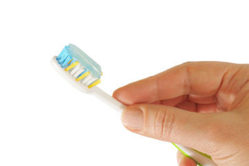 Hand holding a tooth brush with paste isolated