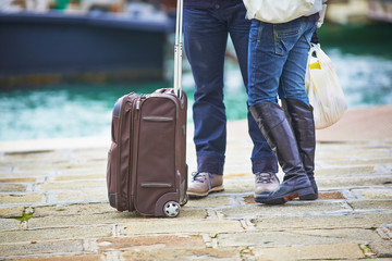 Two turists in Venice waiting for water boat