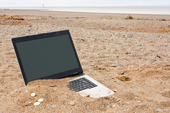 laptop personal computer on the beach - Powered by Adobe