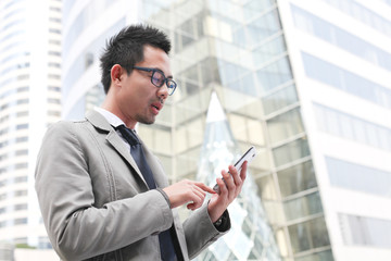 Fototapeta premium Asian business man speaking mobile phone