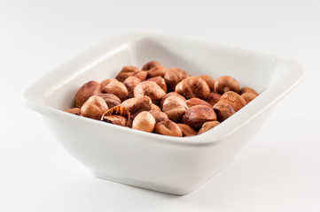 Pile of hazelnuts in a ceramic bowl
