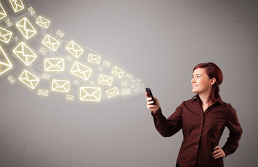 attractive young lady holding a phone with message icons