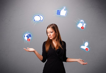 attractive young woman juggling with social network icons