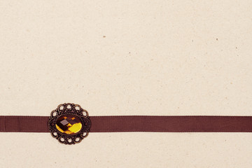 vintage background, old paper with brown ribbon, broche