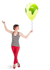 Happy lady holding a green globe balloon