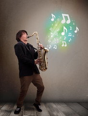 Young musician playing on saxophone while musical notes explodin