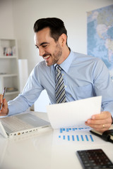 Smiling businessman working in office