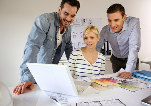 Team of architects presenting construction project
