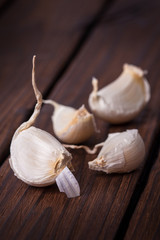 Organic garlic whole and cloves on the wooden background