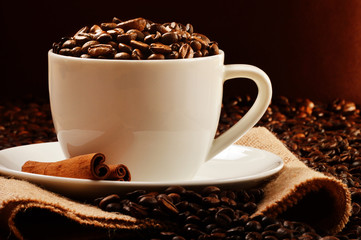 Composition with white cup and coffee beans