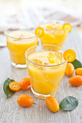Naklejka na ściany i meble Fresh juice from oranges and kumquats