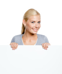 Woman keeping huge sheet of white paper, isolated