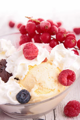 vanilla ice cream with whipped cream and berries