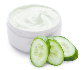 Jar of cream and slices of cucumber.