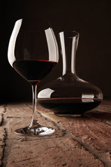 Red wine in decanter on rustic stone floor