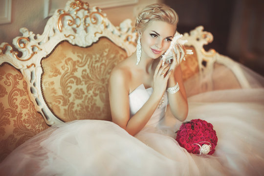 Beautiful bride in wedding dress at home