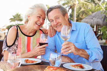 Senior Couple Enjoying Meal In Outdoor Restaurant