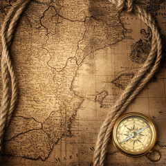 Obraz na płótnie Canvas old compass and rope on vintage map 1732