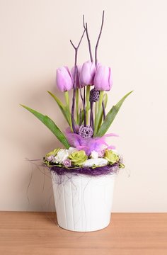 Decorative purple tulips in the white flowerpot.