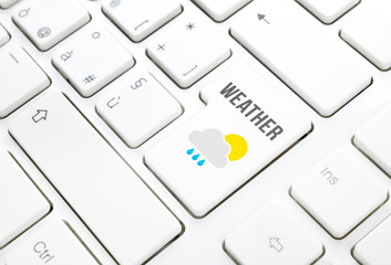 Weather on web concept. Sun cloud rain icon on a keyboard