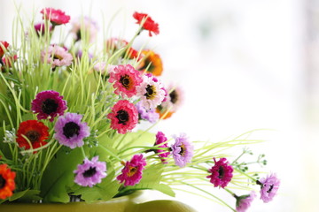 Colorful is Flowers in a Green vase.